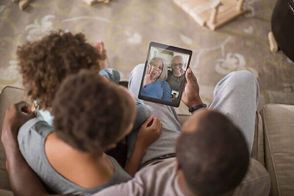 Family holding an ipad on a call