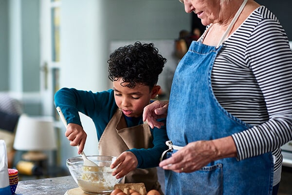 a woman and her grandson baking