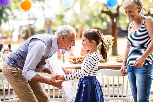 grandparents talking with granddaughter at a party