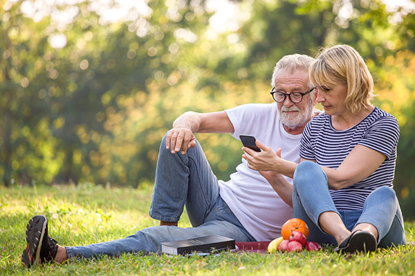 happy senior couple relaxing in park